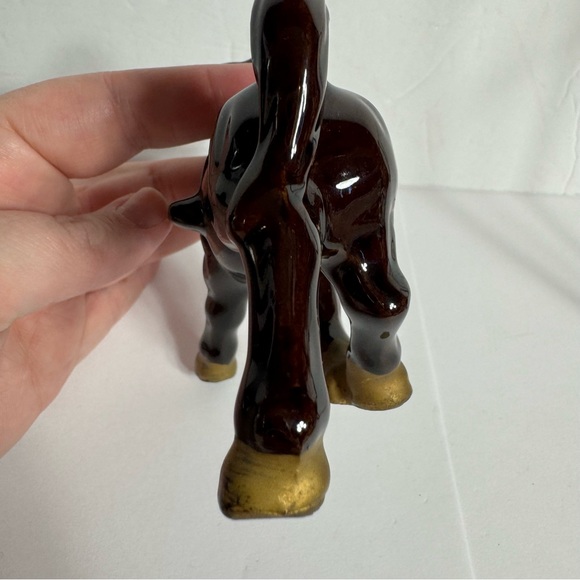 Vintage small brown ceramic horse figurine featuring gold trim and a red saddle. - Picture 8 of 10